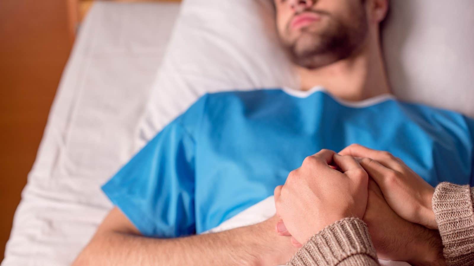 sick man in a hospital bed